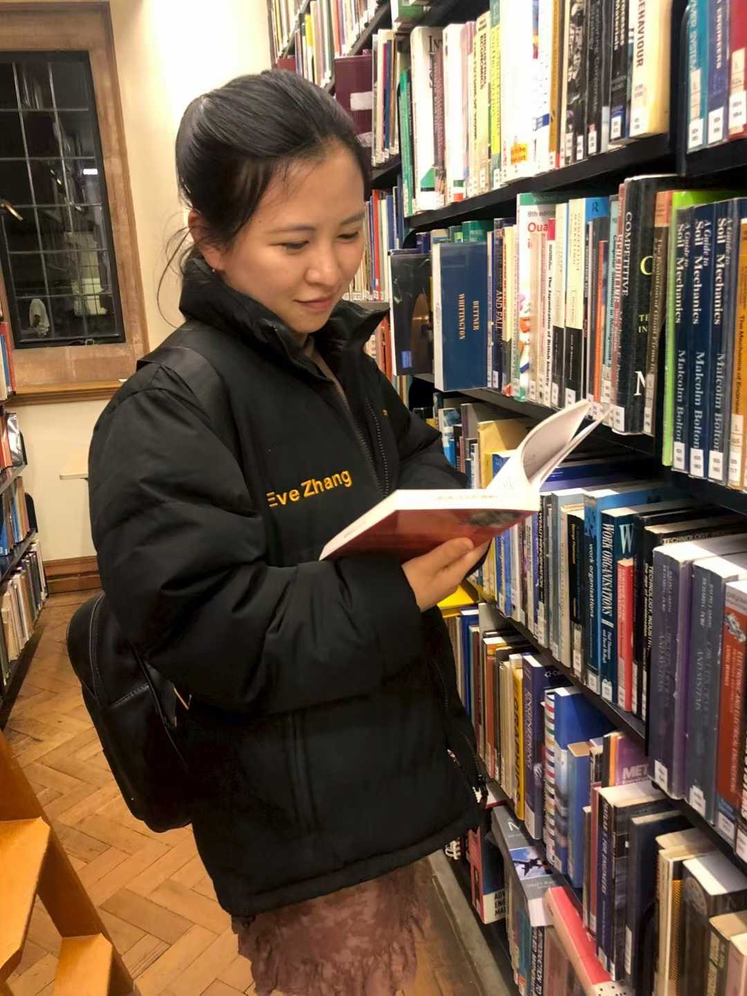 Eve reading in the library